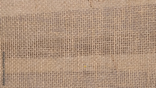 Burlap background and texture. Close view of a piece of used brown burlap cloth.