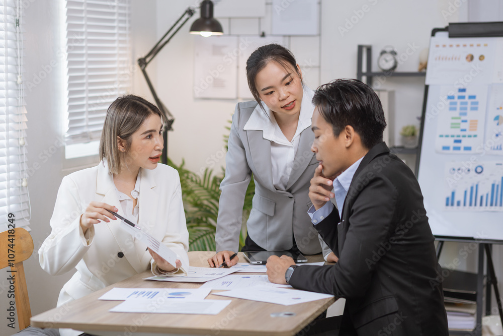 Asian business teamwork working on digital tablet with analysis report and advisor showing plan, Financial analysis and Marketing teamwork concept. Asian business teamwork working on digital tablet with analysis report and advisor showing plan, Financial analysis and Marketing teamwork concept.