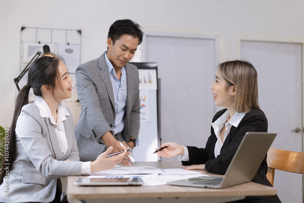 Asian business teamwork working on digital tablet with analysis report and advisor showing plan, Financial analysis and Marketing teamwork concept. Asian business teamwork working on digital tablet with analysis report and advisor showing plan, Financial analysis and Marketing teamwork concept.