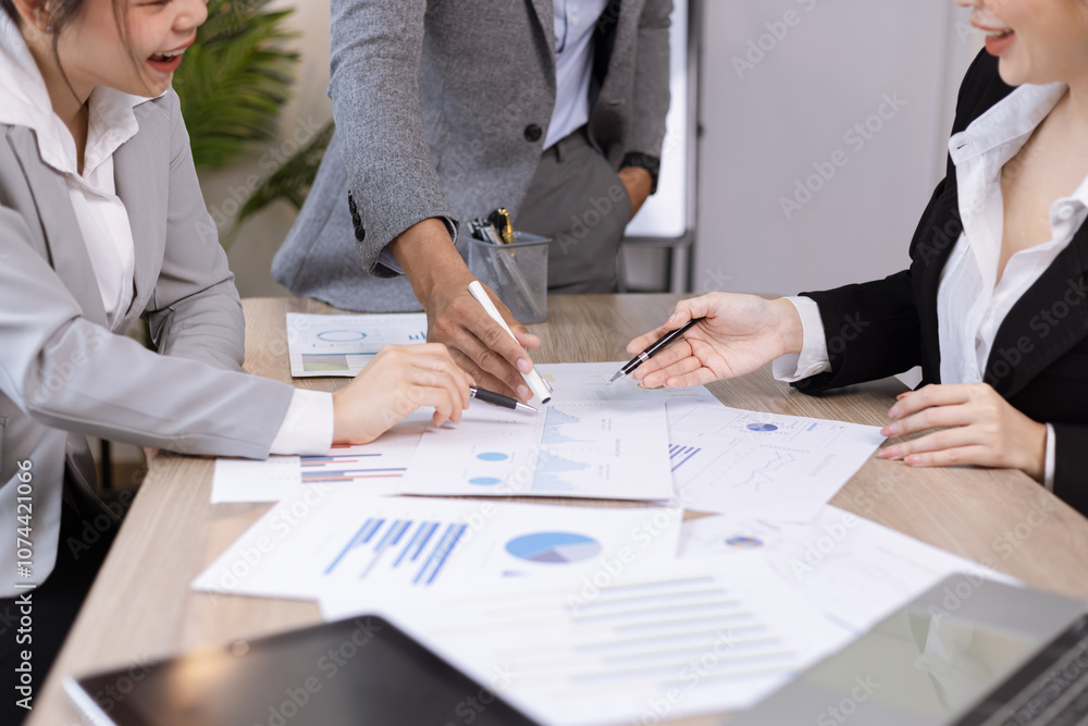 Asian business teamwork working on digital tablet with analysis report and advisor showing plan, Financial analysis and Marketing teamwork concept. Asian business teamwork working on digital tablet with analysis report and advisor showing plan, Financial analysis and Marketing teamwork concept.