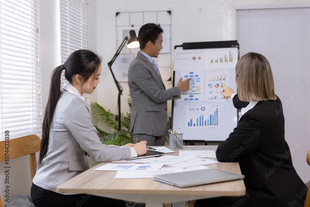 Asian business teamwork working on digital tablet with analysis report and advisor showing plan, Financial analysis and Marketing teamwork concept. Asian business teamwork working on digital tablet with analysis report and advisor showing plan, Financial analysis and Marketing teamwork concept.