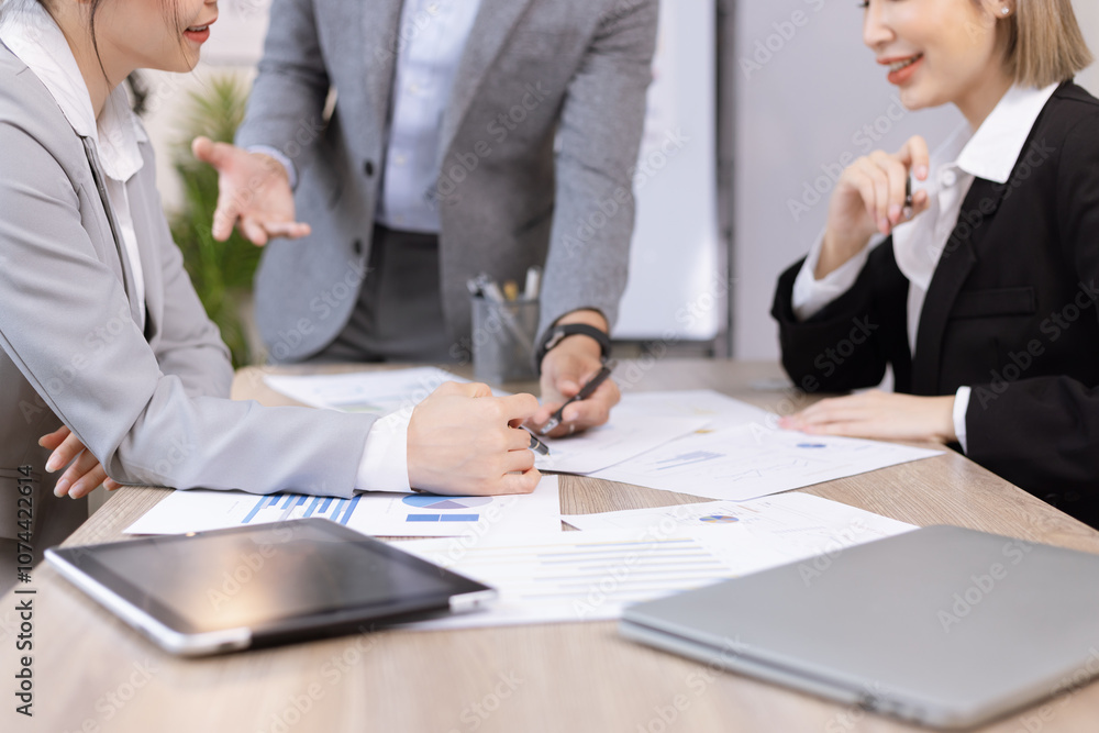Asian business teamwork working on digital tablet with analysis report and advisor showing plan, Financial analysis and Marketing teamwork concept. Asian business teamwork working on digital tablet with analysis report and advisor showing plan, Financial analysis and Marketing teamwork concept.