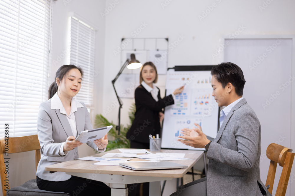Asian business teamwork working on digital tablet with analysis report and advisor showing plan, Financial analysis and Marketing teamwork concept. Asian business teamwork working on digital tablet with analysis report and advisor showing plan, Financial analysis and Marketing teamwork concept.