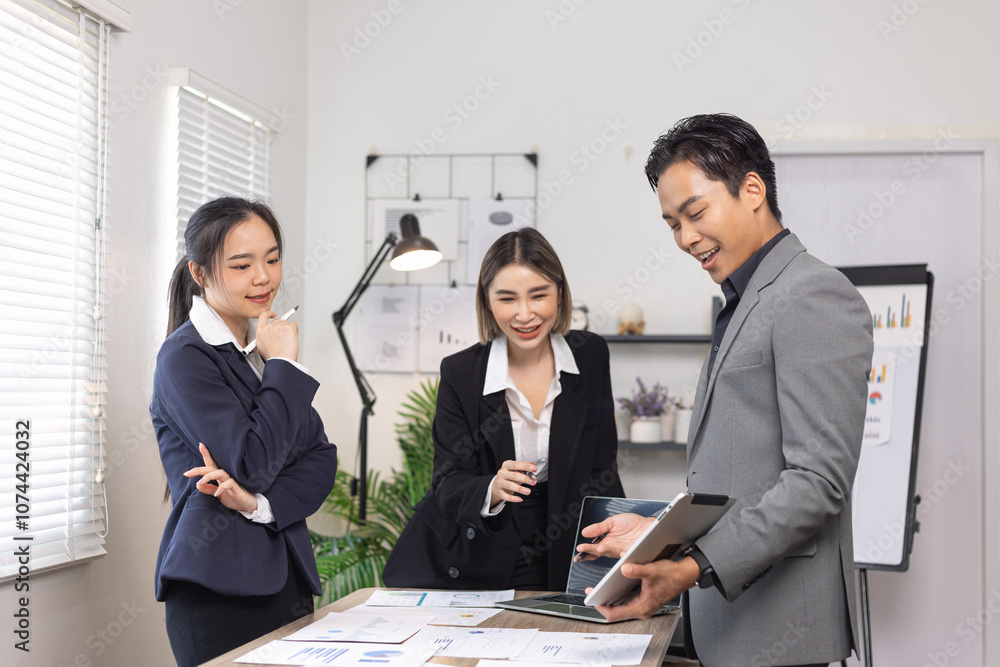 Asian business teamwork working on digital tablet with analysis report and advisor showing plan, Financial analysis and Marketing teamwork concept. Asian business teamwork working on digital tablet with analysis report and advisor showing plan, Financial analysis and Marketing teamwork concept.
