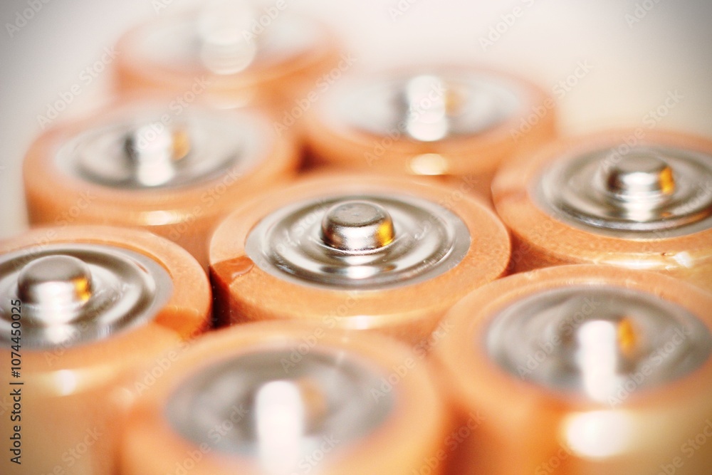 Close up of positive ends of discharged batteries of different sizes and formats, selective focus. Used battery for recycling. Hazardous garbage concept Close up of positive ends of discharged batteries of different sizes and formats, selective focus. Used battery for recycling. Hazardous garbage concept