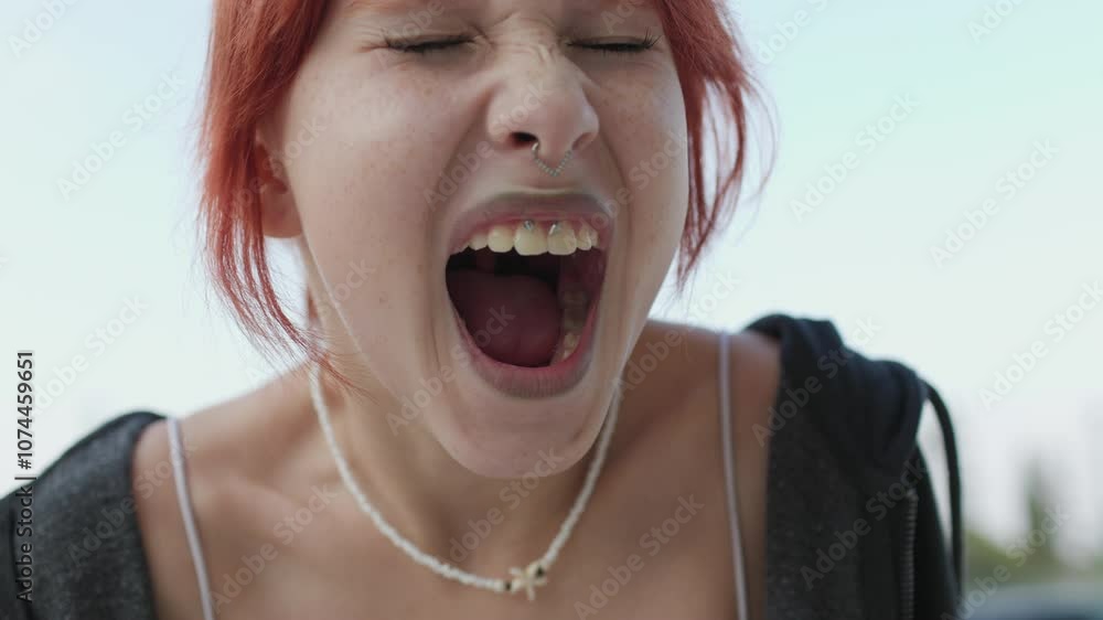Young girl angry and screaming. Upset girl screaming, teenager with facial piercing. shock and emotional breakdown, depression. Young girl angry and screaming. Upset girl screaming, teenager with facial piercing. shock and emotional breakdown, depression.