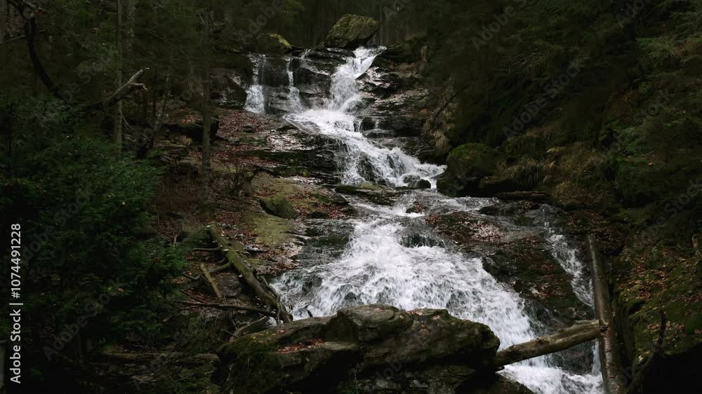 Beautiful waterfall in a gorge among rocks Beautiful waterfall in a gorge among rocks