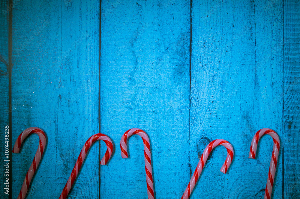 Christmas decorations on a blue wooden background: Christmas tree balls, branches, snowflakes and candy canes, top view, copyspace Christmas decorations on a blue wooden background: Christmas tree balls, branches, snowflakes and candy canes, top view, copyspace