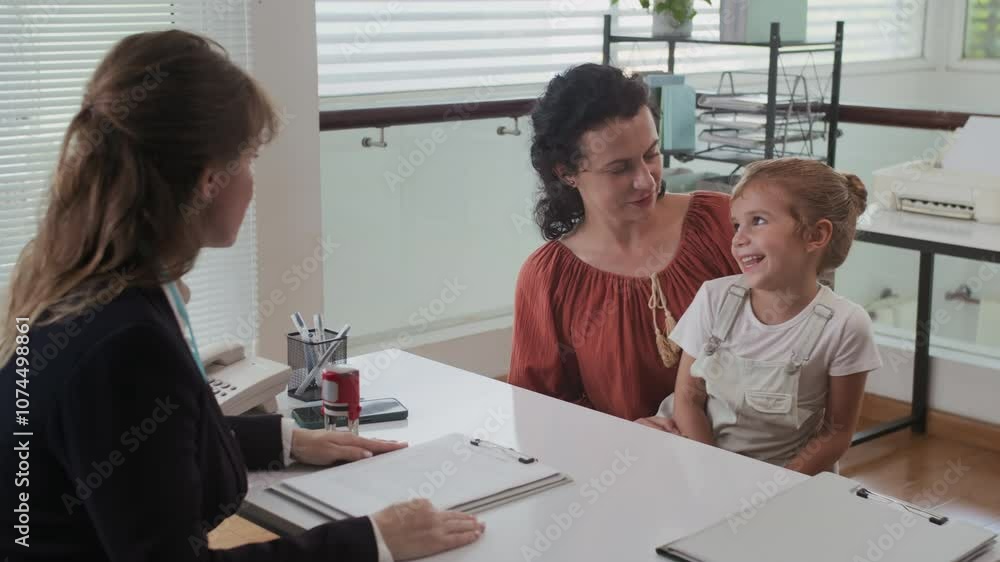 Wide shot of Caucasian mother and her little daughter visiting social office to receive social benefits Wide shot of Caucasian mother and her little daughter visiting social office to receive social benefits