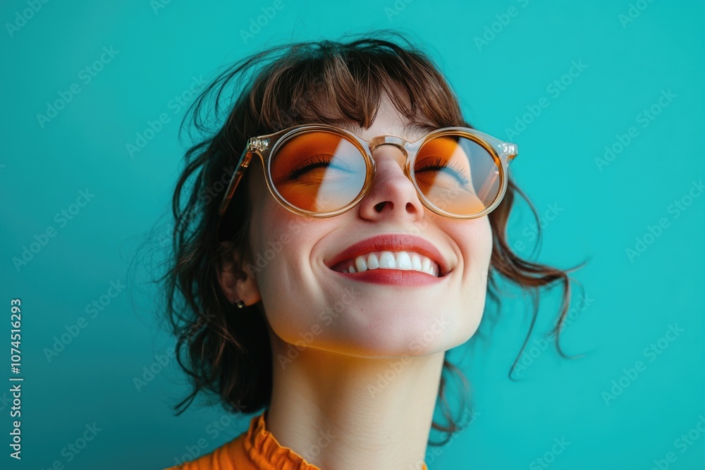 A woman wearing glasses smiles upwards, possibly showing happiness or optimism A woman wearing glasses smiles upwards, possibly showing happiness or optimism
