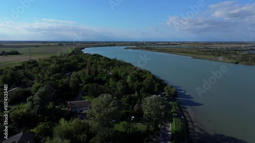 Wallpaper Mural Nicesolo canal, bicycle path, traditional Venetian reed homes park, and commercial seafood fishing off of the Adriatic Sea Torontodigital.ca