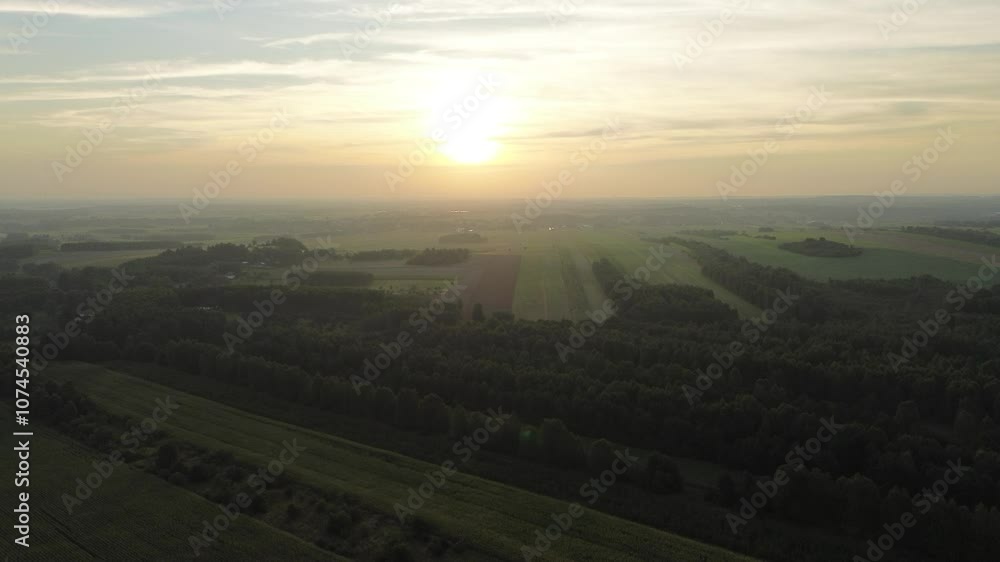 Aerial view of foggy autumn forest with fields and village Aerial view of foggy autumn forest with fields and village
