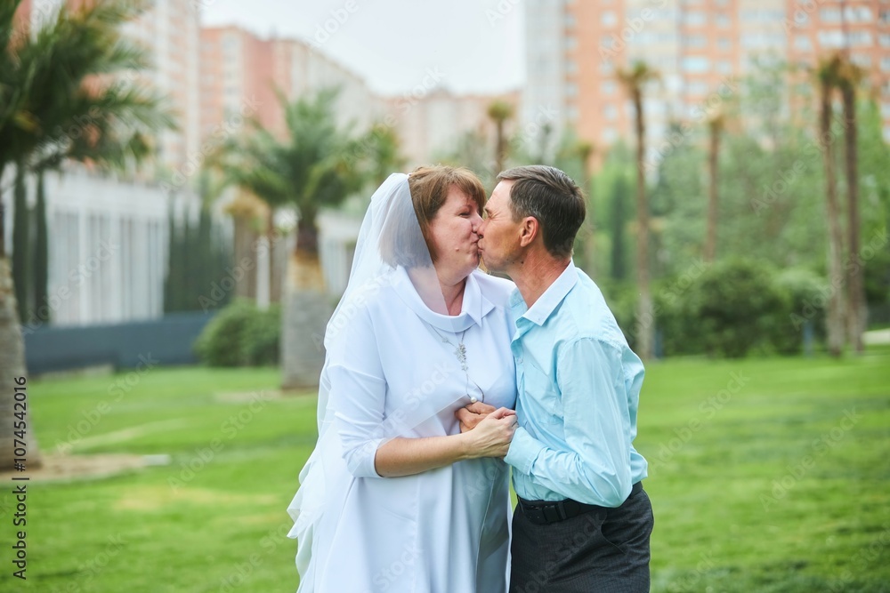 An adult bride and groom. Husband and wife's wedding anniversary photo shoot. We've been together for 30 years. An adult bride and groom. Husband and wife's wedding anniversary photo shoot. We've been together for 30 years.
