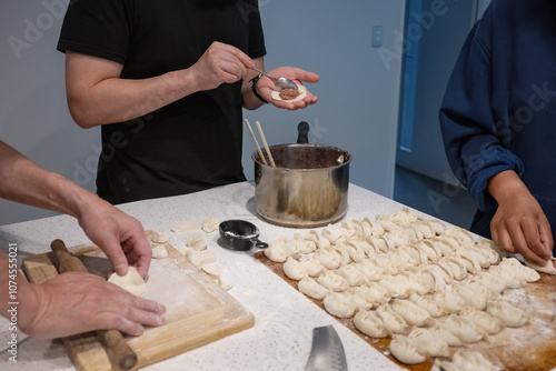 Obraz na płótnie Family making wrappers and dumplings at home. Home cooking. w salonie