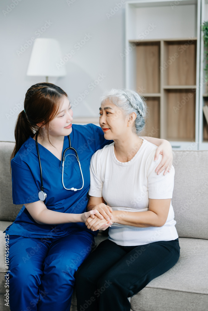 Obraz premium Asian caregiver doctor examine older patient woman therapist nurse at nursing home taking care of senior elderly woman sit on sofa.Medical service concept.