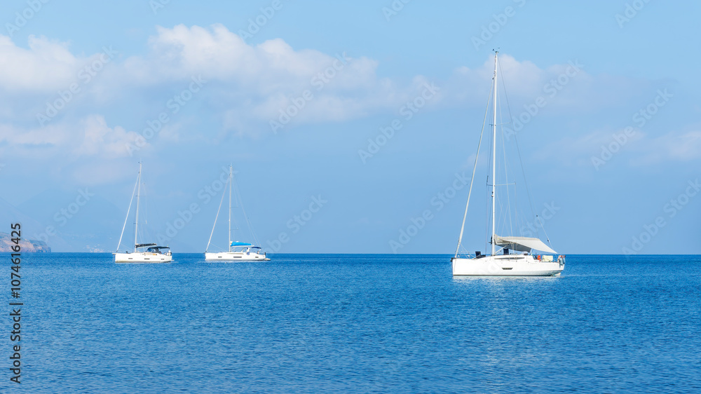sailing yacht boats with white sails in blue sea , seascape of beautiful ships in sea gulf with mountain coast on background sailing yacht boats with white sails in blue sea , seascape of beautiful ships in sea gulf with mountain coast on background