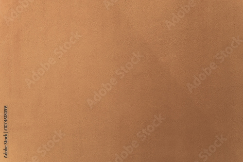 Gold or golden brown and butterum paint on cement wall texture as background.