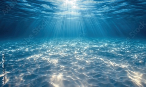 Underwater scene with sunlight rays illuminating ocean surface