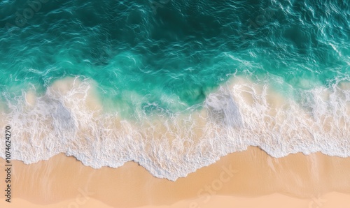 Ocean waves crashing on sandy beach, turquoise water, white foam