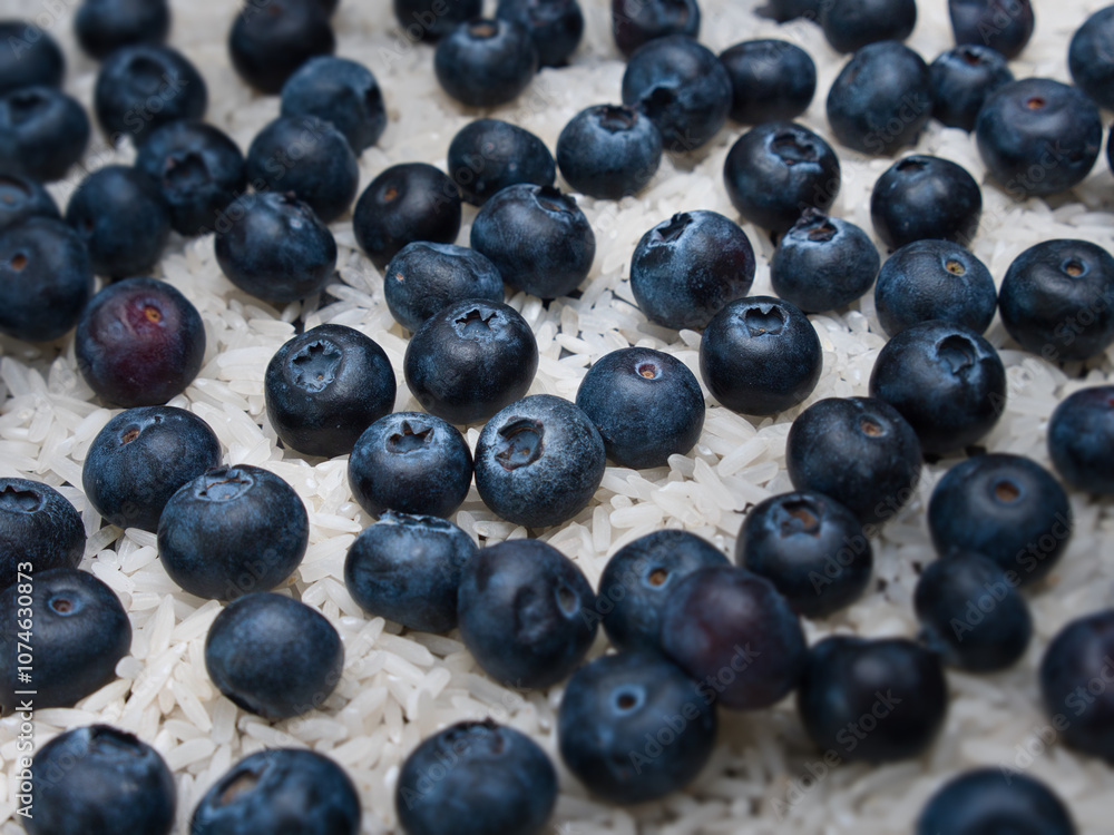 Blueberries lying on rice grains when viewed at different focus level Blueberries lying on rice grains when viewed at different focus level