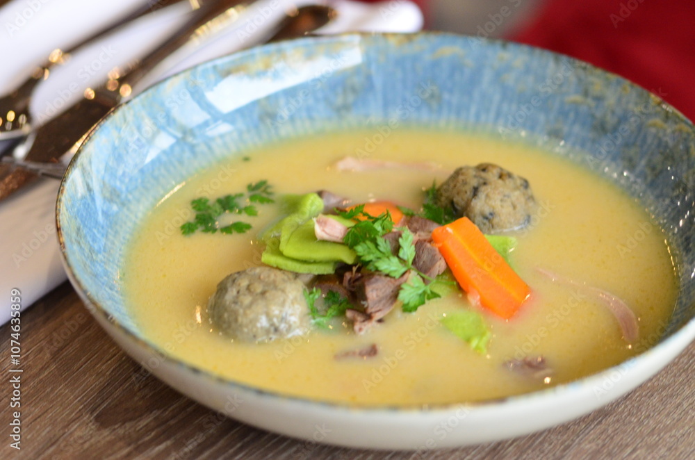 close view of traditional Czech food, Kaldoun goose soup, served food on a plate in a restaurant, wooden table, Saint Martin's goose, traditional Czech holiday food close view of traditional Czech food, Kaldoun goose soup, served food on a plate in a restaurant, wooden table, Saint Martin's goose, traditional Czech holiday food
