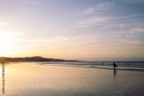 panoramic view of wavy ocean and Famara Beach against mountains at sundown in Teguise, Lanzarote at Canary Islands in Spain, concept of wild nature and marine landscape