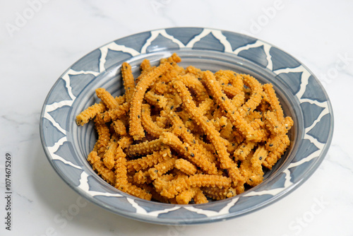 Crunchy fried homemade Chakli sticks with sesame seeds. Chakli is a savory snack from India made out of rice, mixed yellow and green lentils along with spices. Mostly eaten during Diwali festival photo