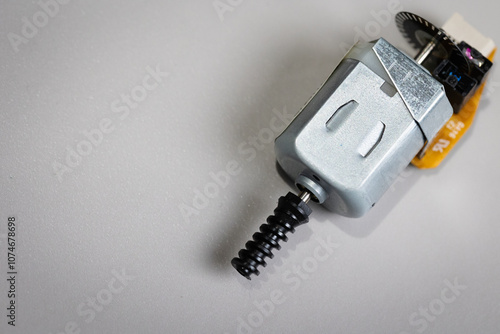 Top down view of DC motor with plastic worm gear and rotary encoder. Motor for electric, mechatronics projects on a desktop. 