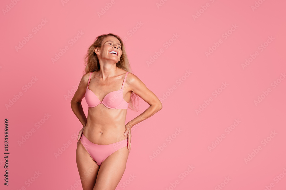 Photo of positive lovely woman wear stylish bra panties look empty space isolated on pink color background Photo of positive lovely woman wear stylish bra panties look empty space isolated on pink color background