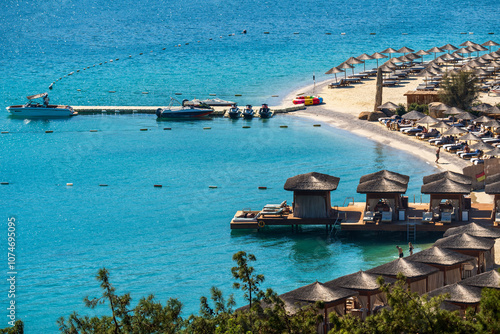 A luxurious beach in Bodrum with bamboo umbrellas and lodges