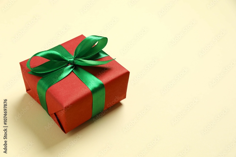 Beautiful gift box tied with bow on color background Beautiful gift box tied with bow on color background