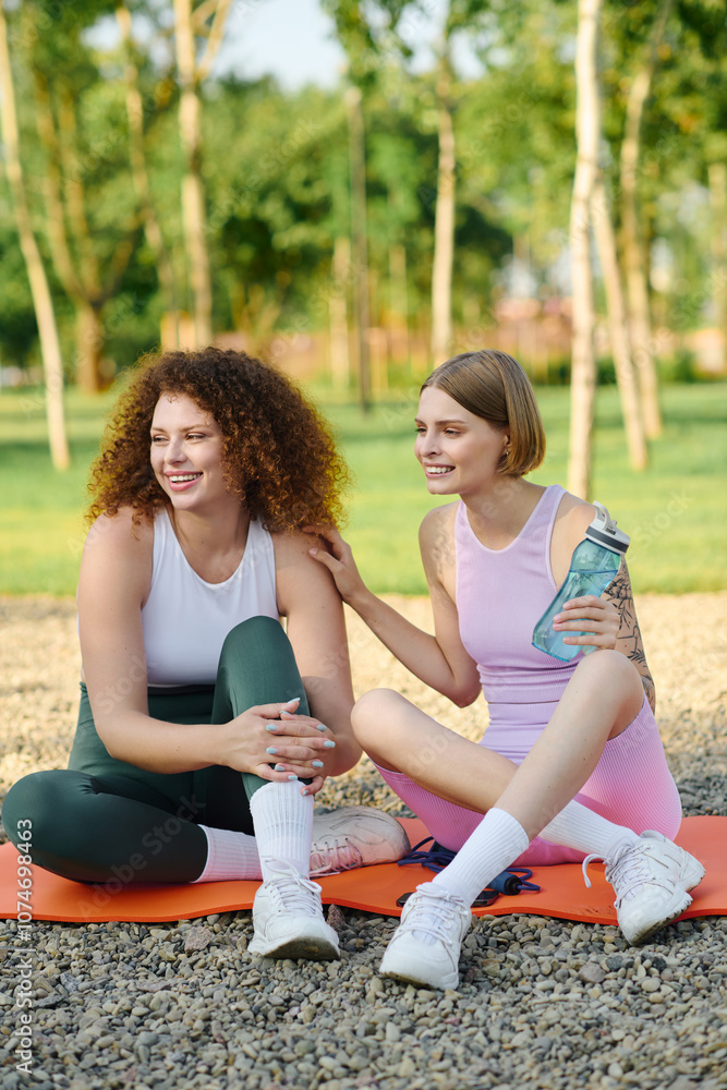 A loving couple relaxes on yoga mats, sharing laughter in a vibrant park. A loving couple relaxes on yoga mats, sharing laughter in a vibrant park.