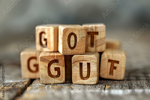 Wooden cubes with gout lettering on wooden table on grey background