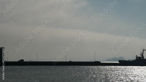 LNG ship on the horizon in Mukran. a peaceful scene overshadowed by controversial energy transports.This is a video excerpt of 9 seconds. The video is 47 MB in size. The frame rate is 50 pps. photo