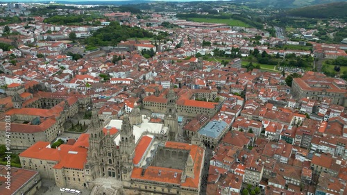 Aerial view of Santiago de Compostela city. View of famous Cathedral of Santiago. Panoramic aerial view of all city. Rooftops of Santiago. Drone circling around Cathedral. Famous travel destination.