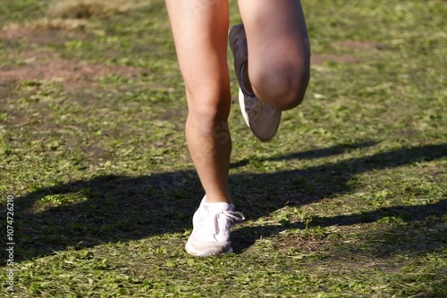 Close-Up of Runner’s Feet on Grass Surface During Race in Sant Cugat del Vallès, Spain photo