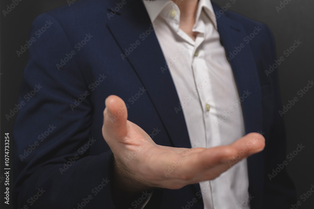 Businessman showing something on the palm of his hand, close-up Businessman showing something on the palm of his hand, close-up