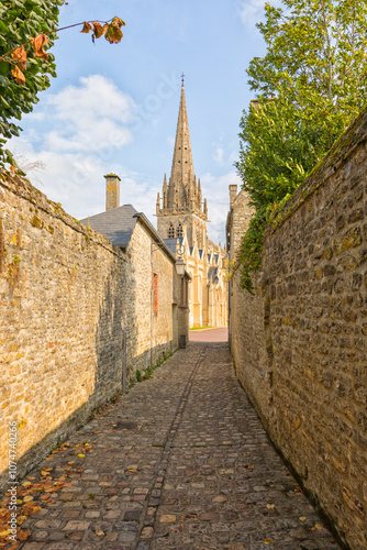 A narrow alley at Carentan, France, leading to Notre-Dame church photo