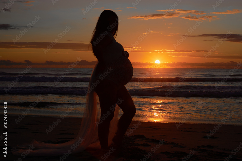 Maternity shoot at sunrise or sunset, pregnant woman on the beach relaxing on the beachside next to the surf and waves. Very pregnant expecting mother, due very soon. Maternity shoot at sunrise or sunset, pregnant woman on the beach relaxing on the beachside next to the surf and waves. Very pregnant expecting mother, due very soon.
