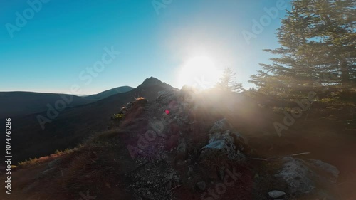 Hiking man walk pov on the top of the hill watching wonderful scenery in mountains during autumn colorful sunset