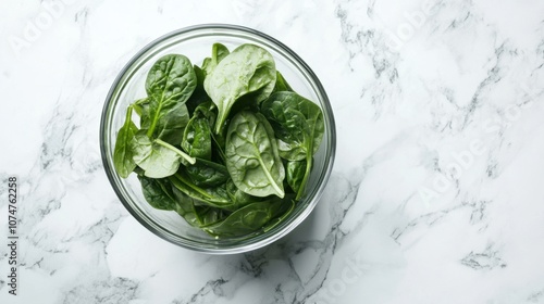 Green smoothie with spinach in a glass on a white marble background photo