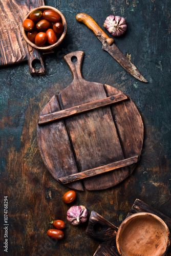 Cooking background: cutting board, cherry tomatoes, and kitchen utensils. Top view.