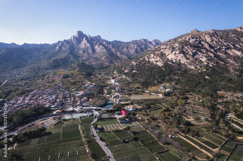 Aerial View of Serene Mountain Village Surrounded by Lush Fields Aerial View of Serene Mountain Village Surrounded by Lush Fields