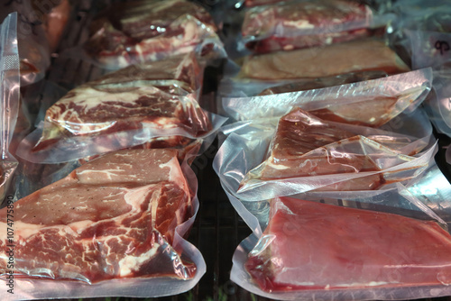 Beef steaks are kept in a special refrigerator before being cooked. Steaks in airtight packaging in the refrigerator. Maturing steaks before cooking. Beef steaks in refrigerator.