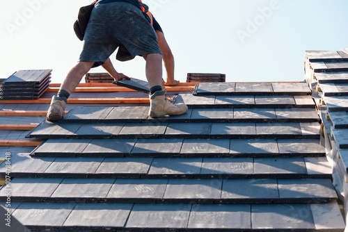 Wallpaper Mural Roofing professional installing slate tiles on a residential building in bright sunlight during the summer Torontodigital.ca