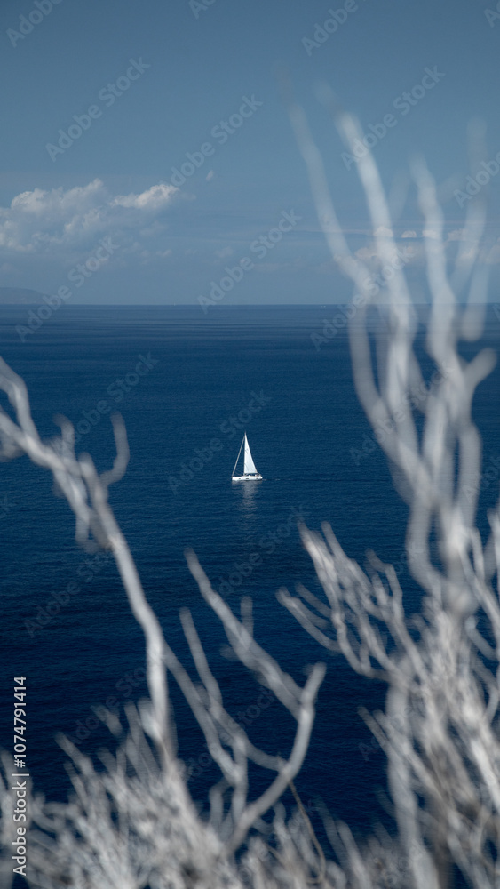 Sailboat against blue sea
