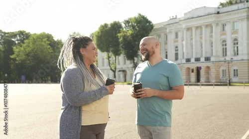 Portrait of happy overweight couple smiling drink coffee and chat outdoor. Cheerful fat man and woman enjoy time spending together. Bset friends, body positive concept. Fat people love themselves photo