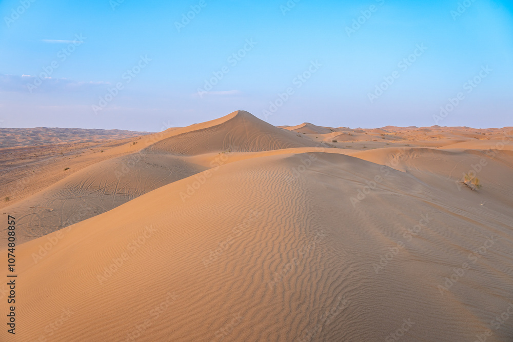 The vibrant sun is slowly setting over a vast desert landscape, Kashan, Iran The vibrant sun is slowly setting over a vast desert landscape, Kashan, Iran