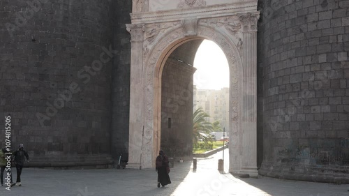 Beautiful evening photo with strong sunshine backlight of Porta Capuana entrance gate to the old town of Napoli old town. Magnificent roman gate in Naples.. photo