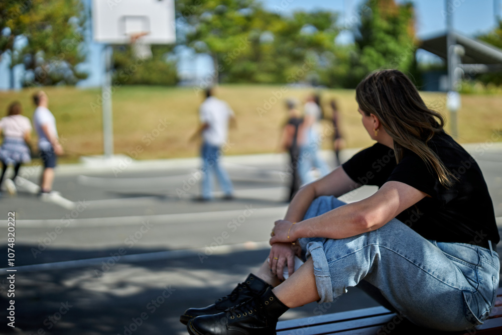 Young woman looking sad, anxious and depressed, introverting and feeling lonely, while in a group of friends. Mental health image, portrayed by an actress. Young woman looking sad, anxious and depressed, introverting and feeling lonely, while in a group of friends. Mental health image, portrayed by an actress.